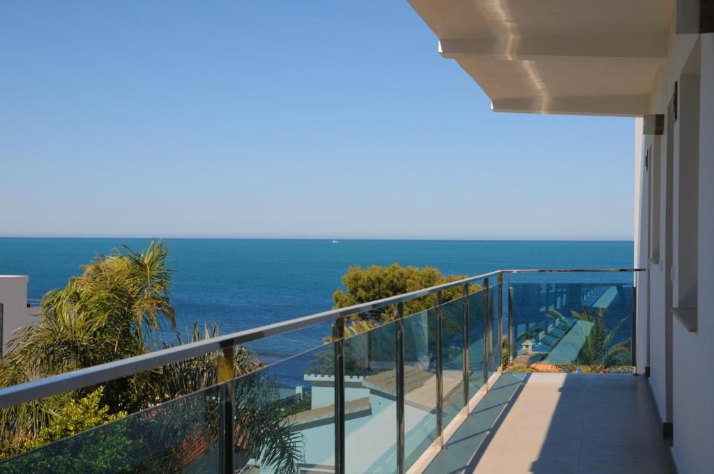 A balcony with a clear view of the sea.