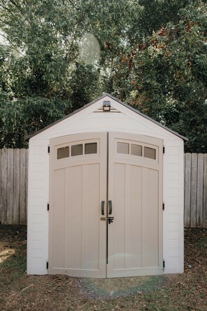 A two-car garage with a peaked roof and a small window at the peak. - Copperfield Retreat 3BR | Pet-Friendly Escape (Montgomery)