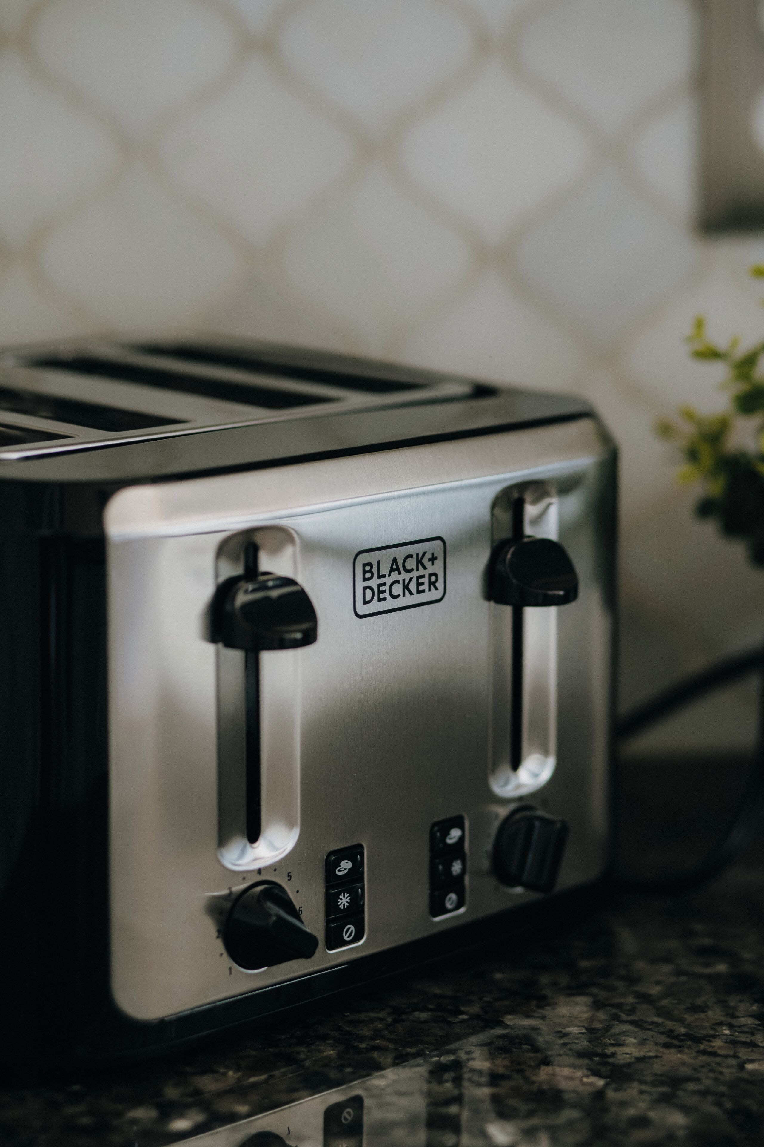 A BLACK+DECKER toaster with two slots, a dial, and a power button.
