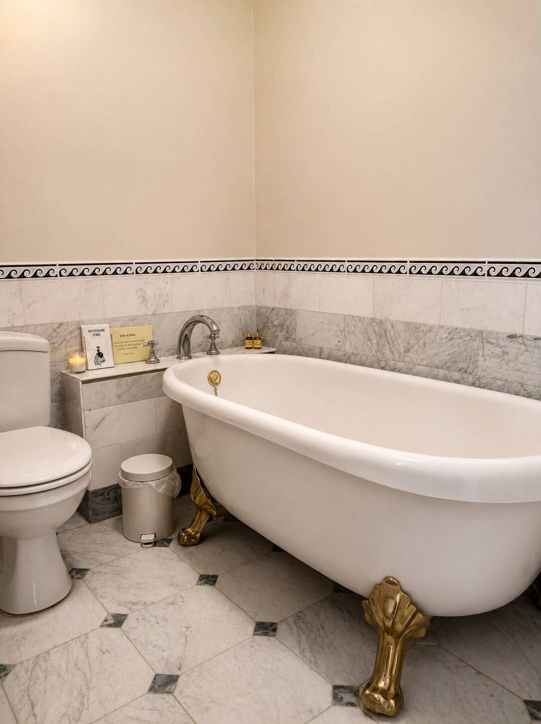 A bathroom with a white bathtub, a toilet, and a trash can.