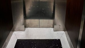 An elevator with stainless steel doors, a digital display, and emergency instructions. - Haven Hotel (Ho Chi Minh City)