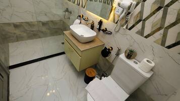 Separate tub and shower, rainfall showerhead, designer toiletries