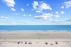 A wide beach with a clear sky and calm sea. - Arcadian 1 | 2 Bedroom Oceanfront Condo (Myrtle Beach)