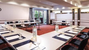 A conference room with long tables, chairs, and a whiteboard. - 4 Person Holiday Park Home in Offenburg (Offenburg)