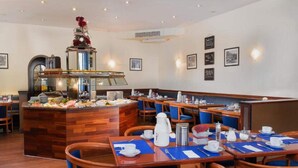 A restaurant with wooden tables, blue chairs, a buffet counter, and wall-mounted pictures. - 4 Person Holiday Park Home in Offenburg (Offenburg)
