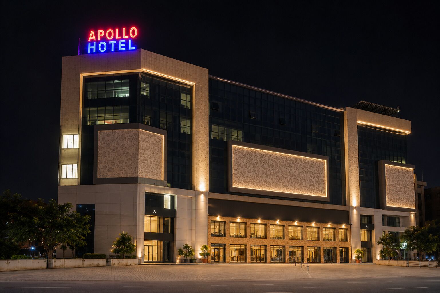 A modern hotel with a prominent neon sign, large windows, and a well-lit facade.