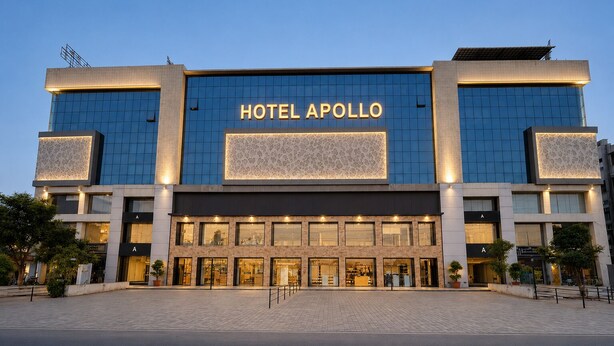 A modern hotel with a prominent 'HOTEL APOLLO' sign, large windows, and a paved entrance area. - Hotel Apollo SpRing Road Odhav Ahemdabad (Ahmedabad)