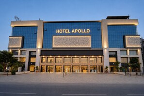 A modern hotel with a prominent 'HOTEL APOLLO' sign, large windows, and a paved entrance area. - Hotel Apollo SpRing Road Odhav Ahemdabad (Ahmedabad)