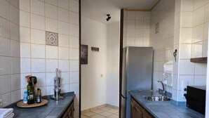 A kitchen with tiled walls, a refrigerator, a sink, and a microwave. - Private Beach Apartment WiFi- MorroJable- 2 Bedrooms (Morro Jable)