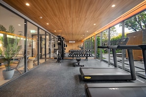 A gym with treadmills, weight machines, and dumbbells. - Laguna Beach Residences Seashore by Banyan Living (Choeng Thale)