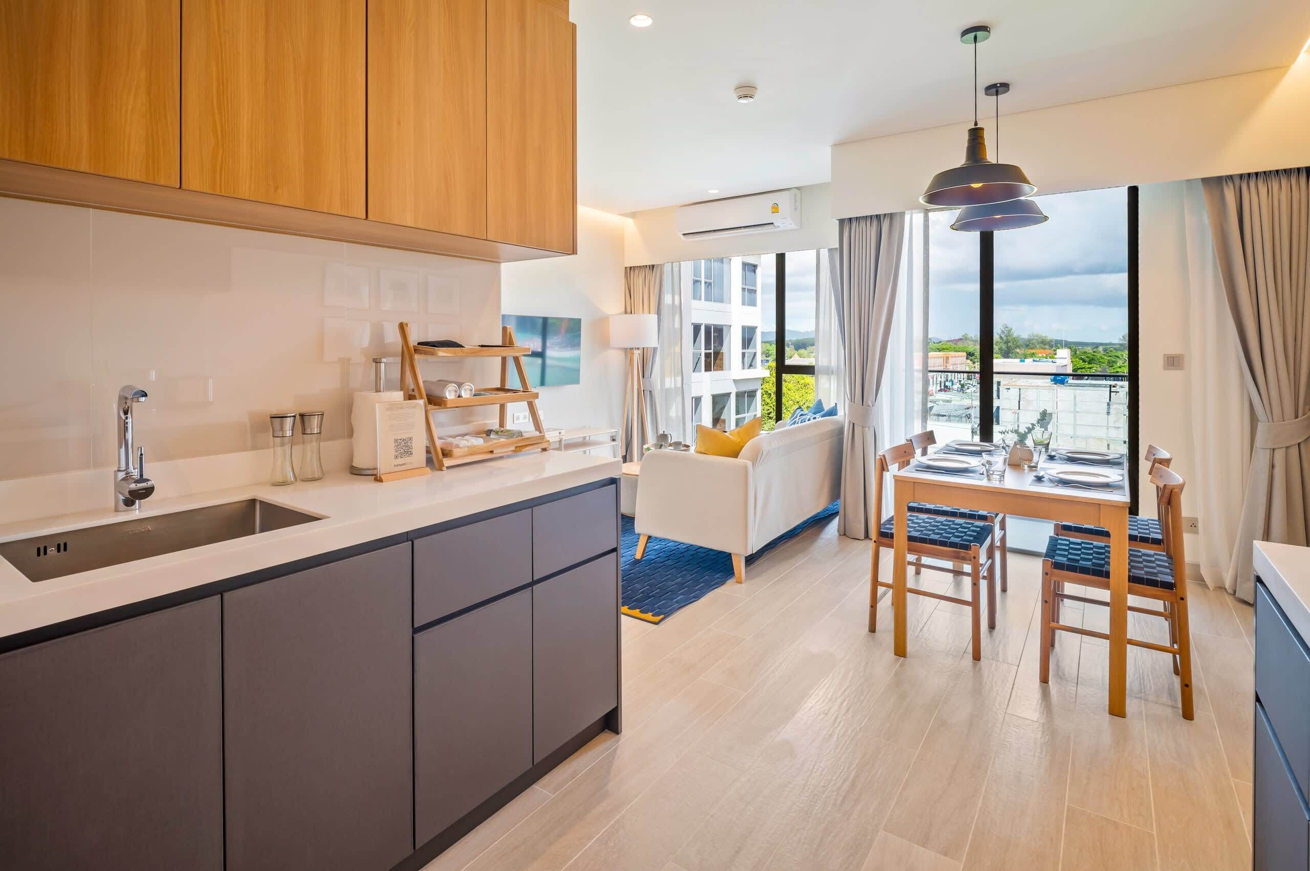 A modern kitchen with a built-in sink, wooden cabinets, and a dining area with a table and chairs.