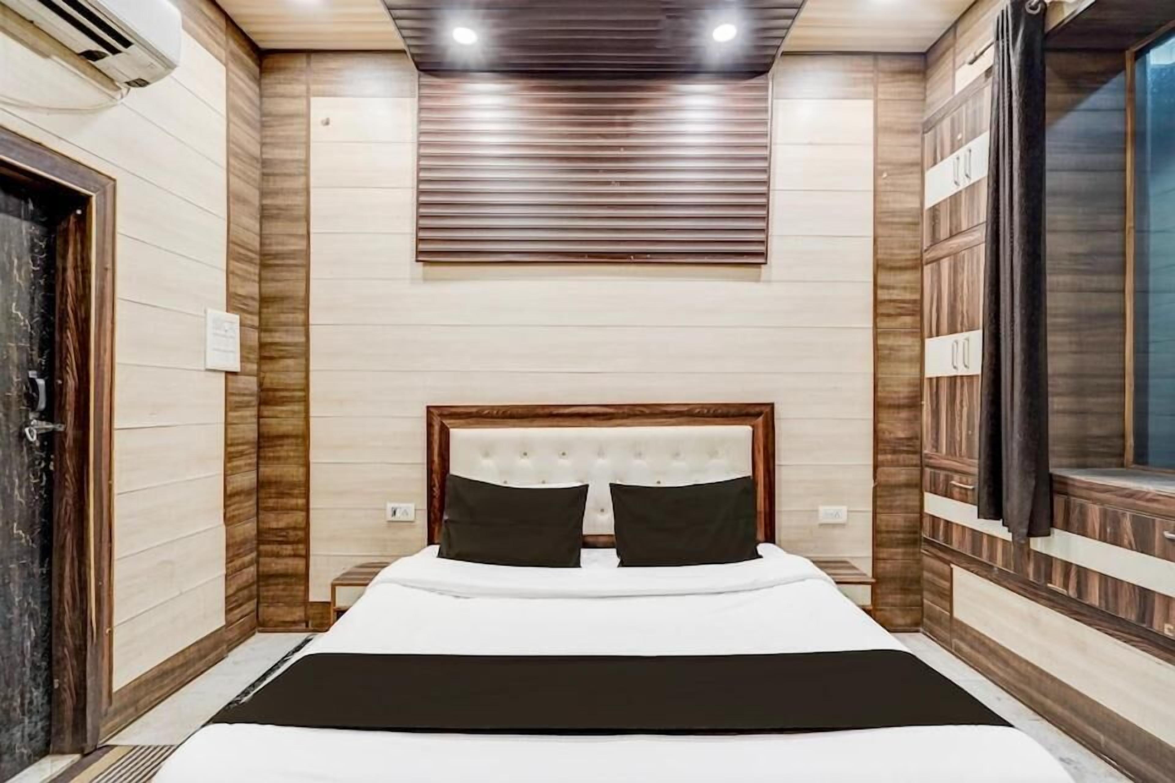 Une chambre d’hôtel avec un lit, une fenêtre et une porte.