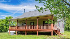 A two-story house with a porch, a chimney, and a yard. - Glatts - Cabin located in Shunk (Shunk)