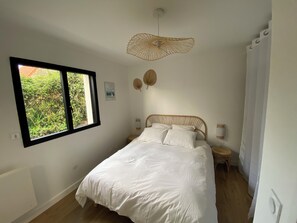 A bedroom with a bed, a window, a wall-mounted light fixture, and a small bedside table. - Quiet & comfortable vacation home - 1500m from the beach 3 bedrooms 2 bathrooms - sleeps 7 (Dragey-Ronthon)