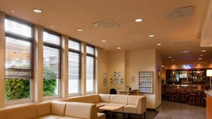 A hotel lobby with a seating area, a reception desk, and a bar. - 2 Person Holiday Park Home in Neu-isenburg (Neu-Isenburg)