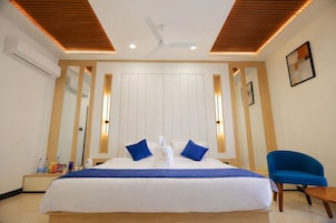 Luxury Suite, Balcony, City View | In-room safe, desk, laptop workspace, blackout drapes