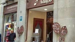 A hotel entrance with a sign reading 'HOTEL Adagio,' a visible room number '21,' and a 'H' indicating a handicap-accessible entrance. - Hotel Adagio (Barcelona)
