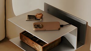 A modern desk with a smartphone, a charger, and a drawer. - Hotel Adagio (Barcelona)