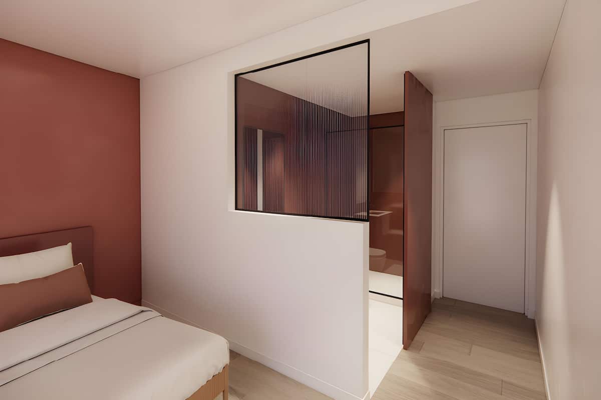 A modern bedroom with a bed, a mirror, and a walk-in closet.