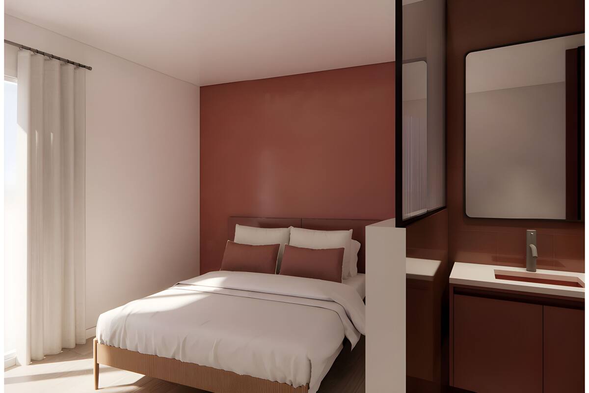 A modern bedroom with a bed, a nightstand, a mirror, and a window with curtains.