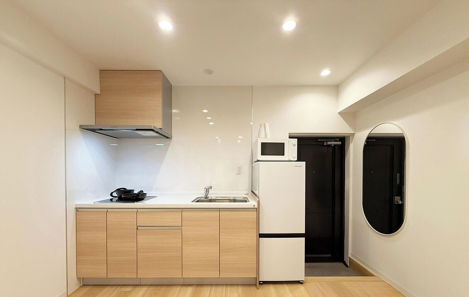 A compact kitchen with a microwave, refrigerator, and stove.