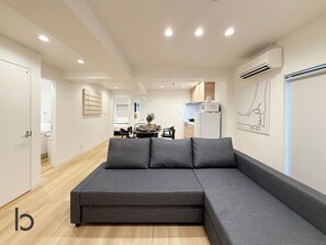 Comfort Apartment, Balcony | Living area | 55-inch Smart TV with cable channels - ITO BLD (Hiroshima City)