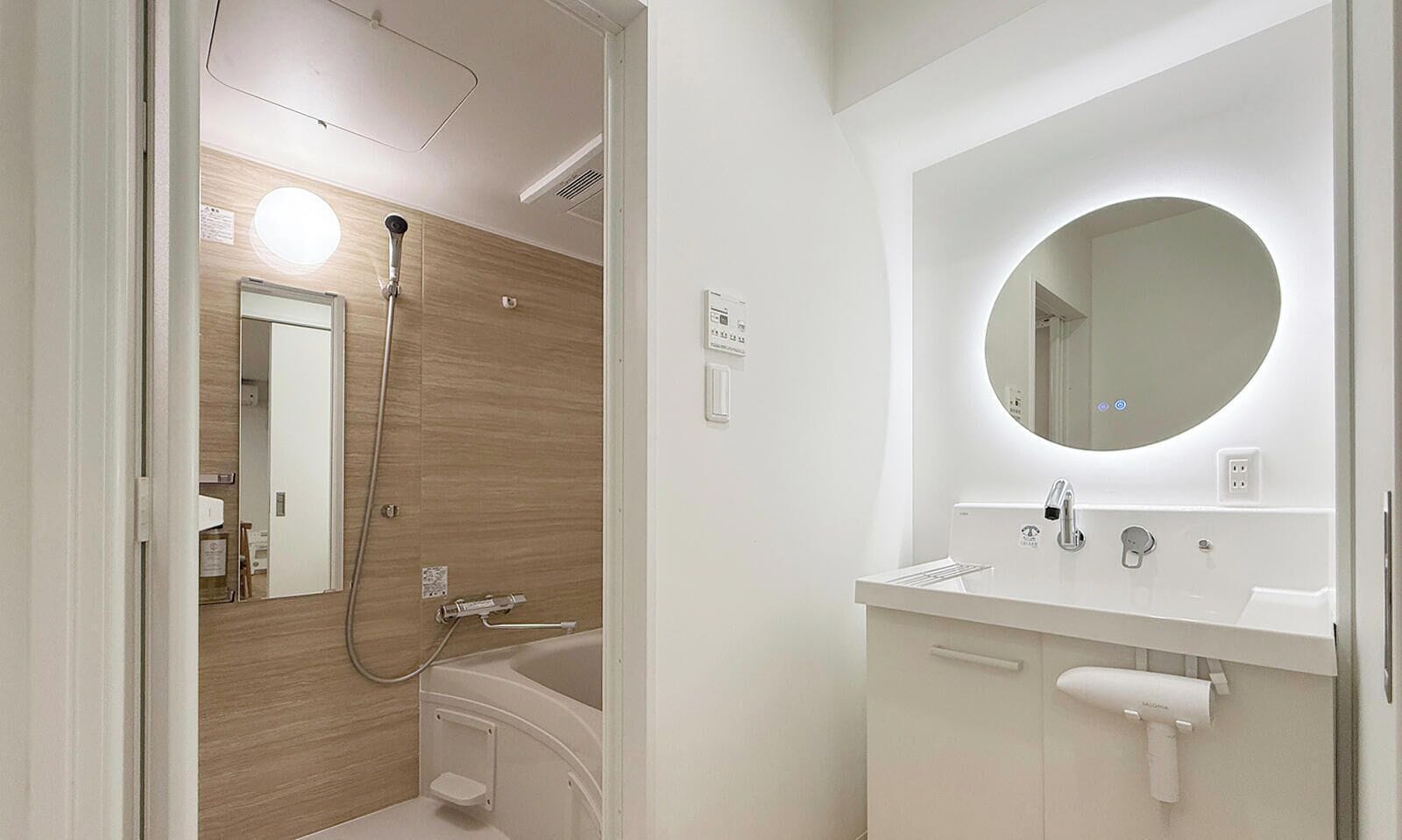 A modern bathroom with a shower, toilet, and sink.