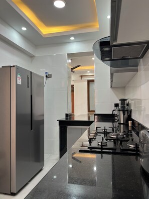A modern kitchen with a stainless steel refrigerator, a gas stove, and a built-in oven. - Luxury Living in Nyali — Wake up to breathtaking ocean view (Mombasa)