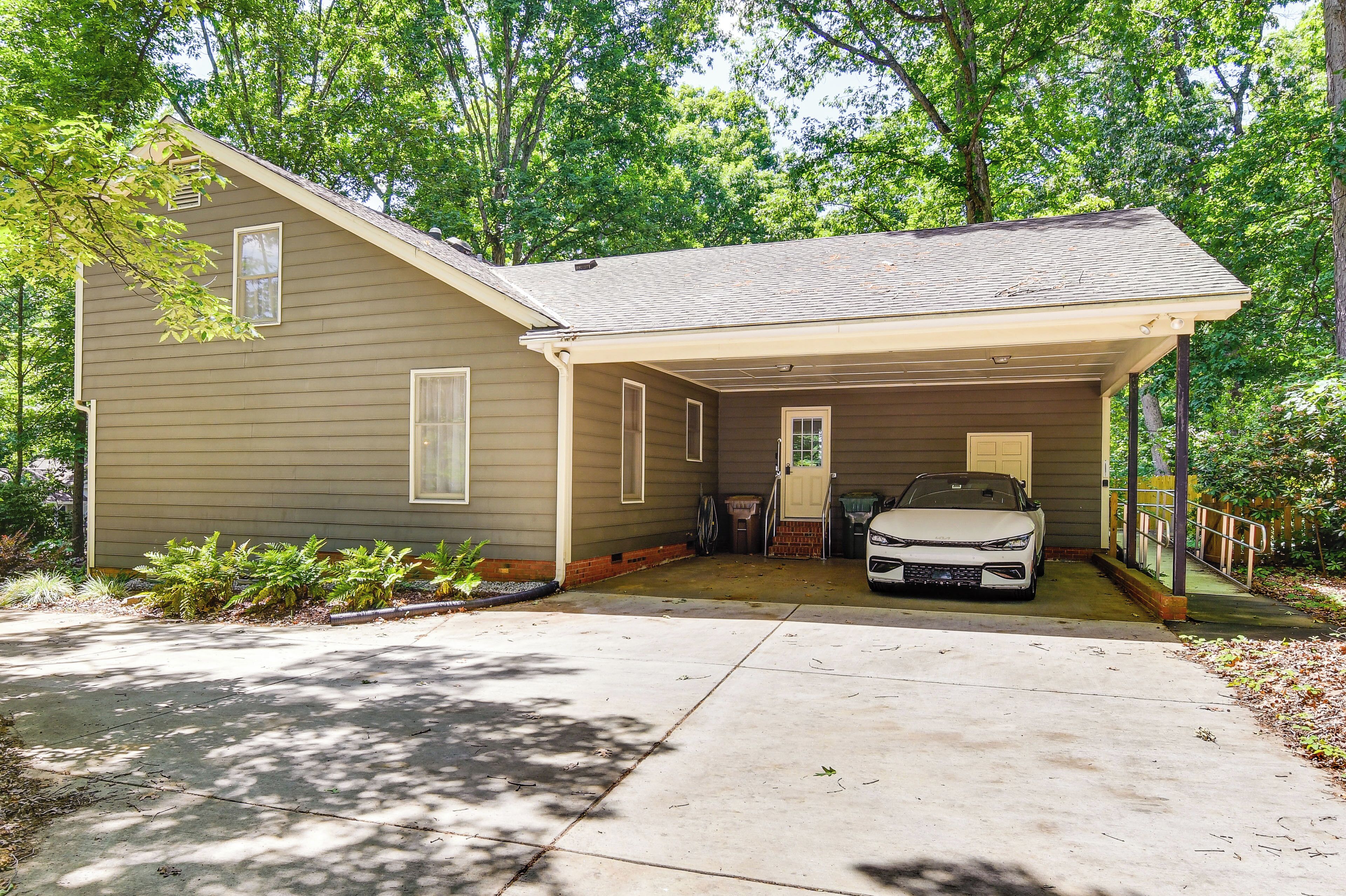 A single-story house with a covered garage and a driveway.