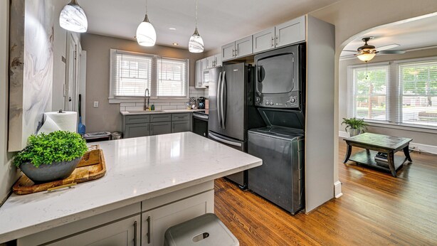 A modern kitchen with a marble countertop, stainless steel appliances, and pendant lighting. - Charlotte Duplex Close to Uptown and Sports (Charlotte)