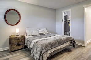A bedroom with a bed, bedside table, mirror, wardrobe, and a built-in closet. - 3 Mi to Dtwn: Pet-friendly Studio in Huntsville (Huntsville)