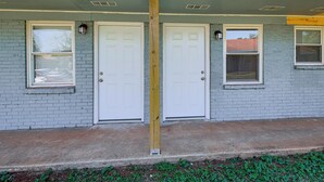 A building with two white doors, a wooden post, and a window with a metal bracket. - 3 Mi to Dtwn: Pet-friendly Studio in Huntsville (Huntsville)
