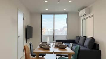 City Apartment | Living area | 65-inch Smart TV with cable channels