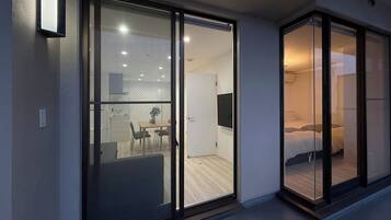 A modern interior with a dining area, a bed, and a TV.