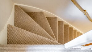 A spiral staircase with a textured wall and a white handrail. - Exceptional woodland cottage in Constable Country - Cosgrove Lodge (Colchester)