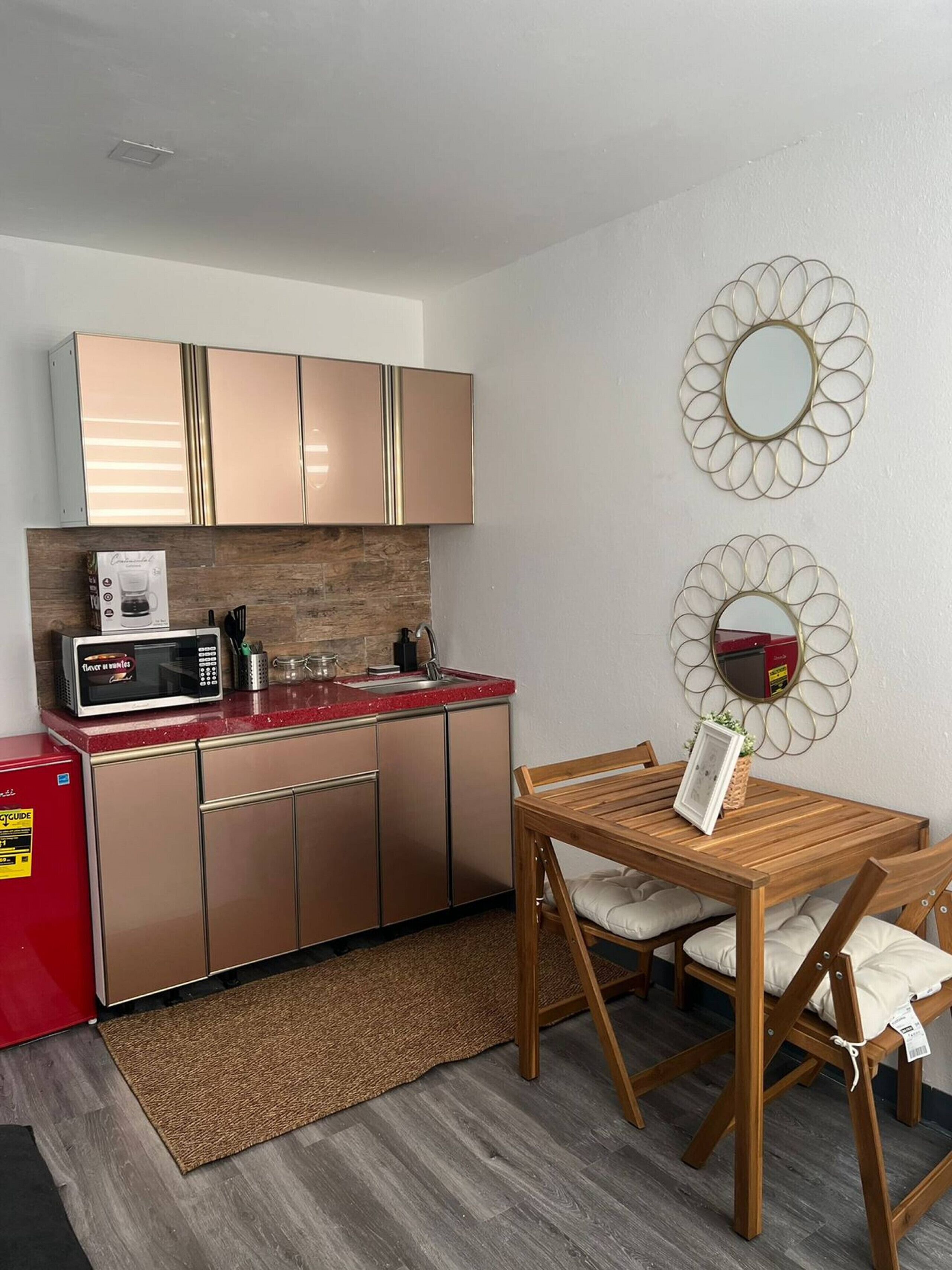 Coffee/tea maker, microwave, cookware/dishes/utensils, dining table