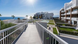 A modern hotel with a rooftop terrace, a clear view of the ocean, and a well-maintained garden. - Luxury Pool View Isea 1111 (Torrox)