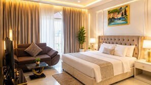 A modern bedroom with a large bed, a sofa, a TV, and a painting on the wall. - UBUMWE APARTHOTEL KIGALI (Kigali)