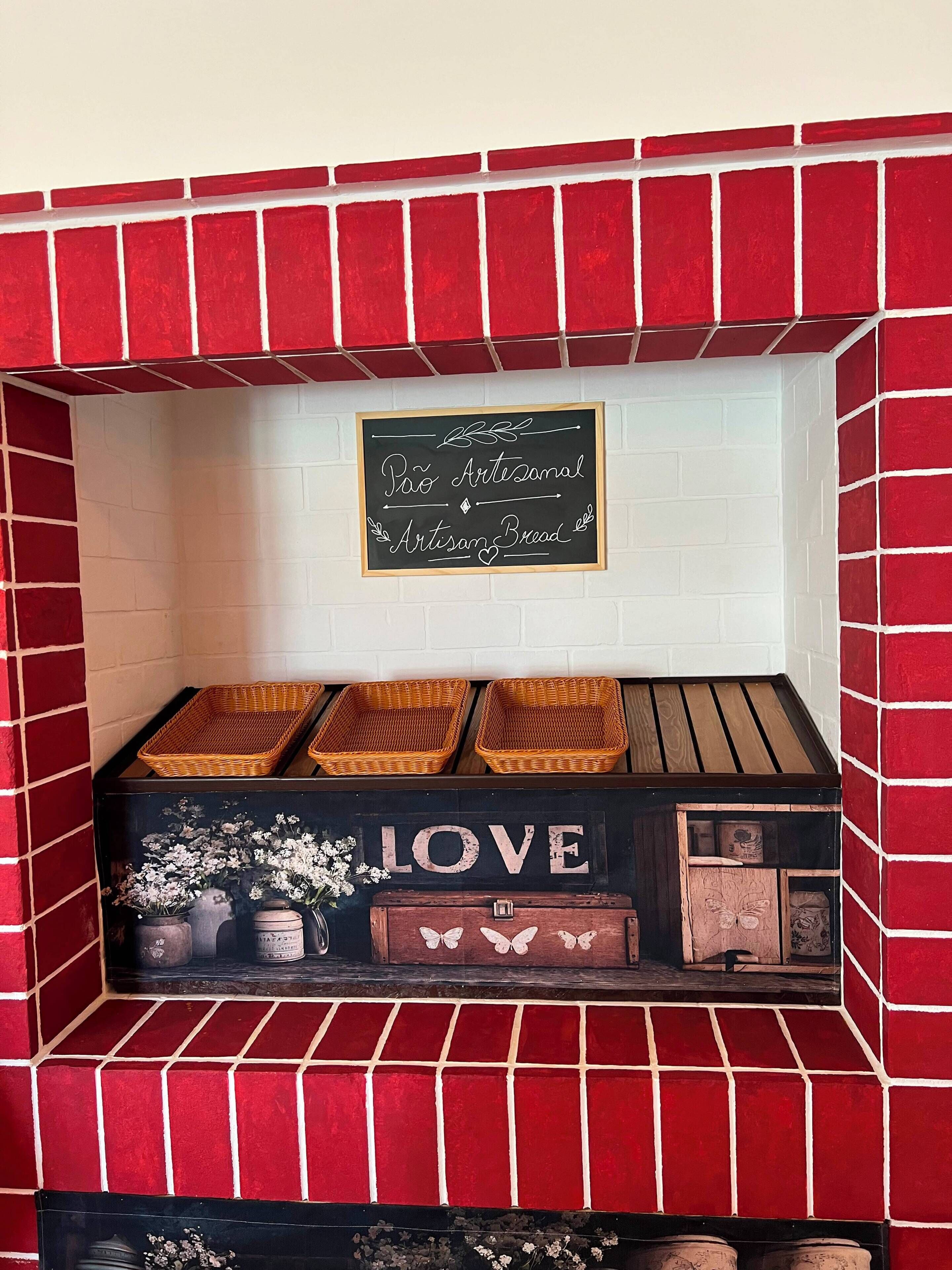 A brick fireplace with a sign above it stating 'Pro Artisan Bread.'
