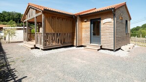 Uma cabana de madeira com varanda e uma porta com a placa 'Le Jurka'.