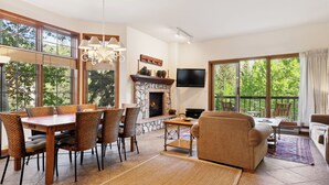 Amplia sala de estar con chimenea, mesa de comedor y asientos cómodos.