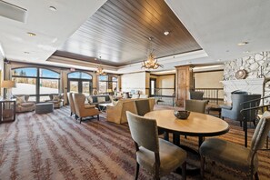 A spacious lobby with a high ceiling, large windows, and a fireplace. - Beaver Creek Ski-In/Ski-Out w/Mountain View| UB407 (Beaver Creek)