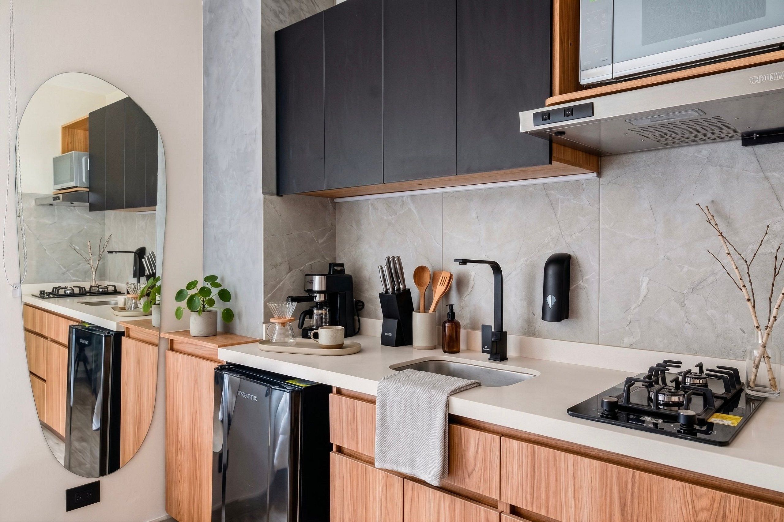 A modern kitchen with a built-in dishwasher, a coffee maker, and a gas stove.