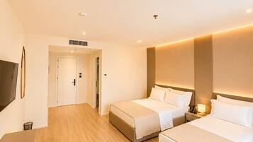 Superior Triple Room, Balcony | In-room safe, desk, laptop workspace, blackout drapes