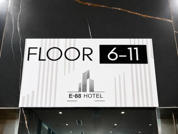 A sign indicating 'FLOOR 6-11' with the hotel name 'E-88 HOTEL' and a simple building icon. - E-88 Hotel (Tirana)
