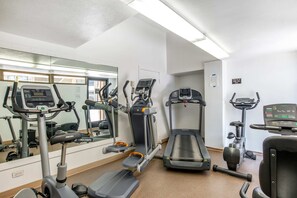 A gym with treadmills, an elliptical, and a stationary bike. - The Moana Horizon Suite Ala Moana 28th Floor (Honolulu)