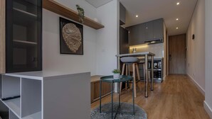 Une cuisine moderne avec des meubles en bois, un îlot central et un coin repas équipé de tabourets.