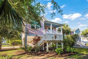 A two-story house with a porch, a driveway, and a flag. - Coastal Gem, by the beach and lake (Carolina Beach)