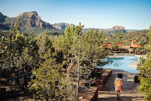A resort with a swimming pool, pine trees, and a mountain backdrop. - Hyatt Pinon Pointe (Sedona)