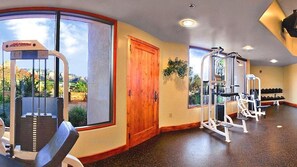 A gym with exercise equipment, large windows, and a door. - Hyatt Pinon Pointe (Sedona)